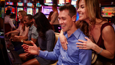 couple playing slots at River City Casino